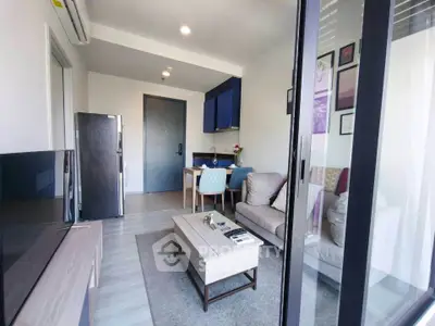 Modern living room with stylish decor and open layout, featuring a cozy seating area and dining space.