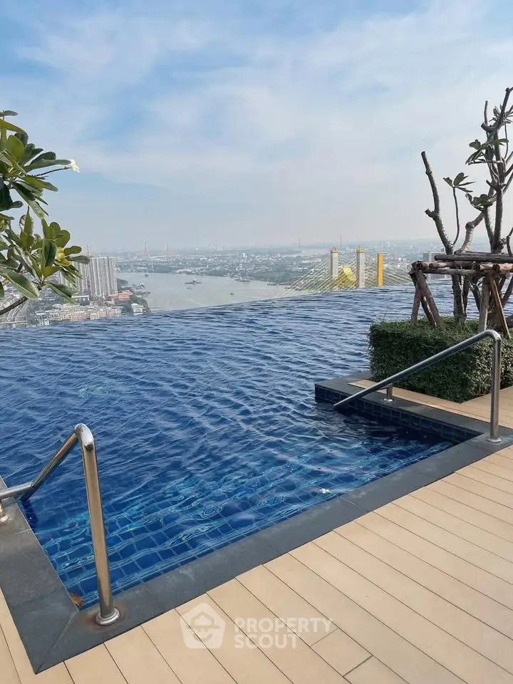 Stunning rooftop infinity pool with breathtaking city and river views, perfect for luxury living.