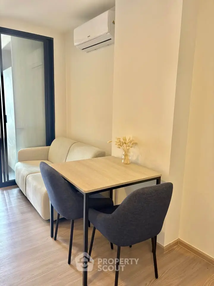 Cozy modern living room with dining area and air conditioning