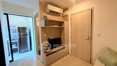 Modern apartment interior with air conditioning and sleek kitchen appliances.