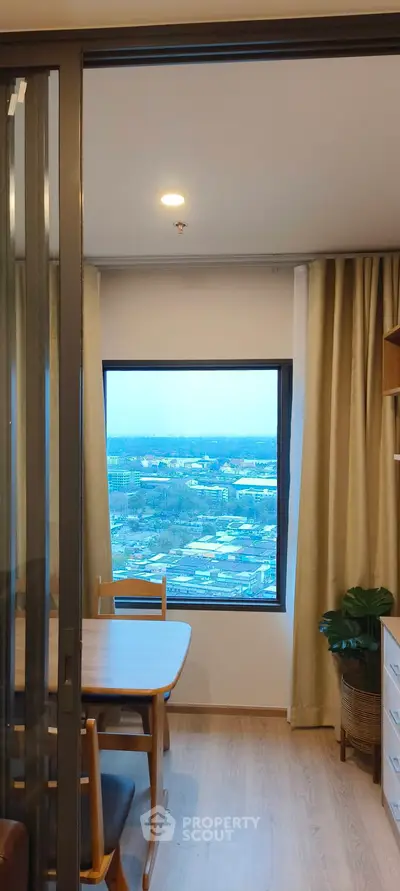 Modern apartment dining area with panoramic city view and stylish decor