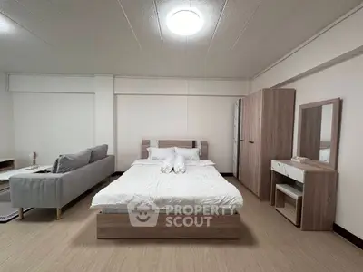 Spacious bedroom with modern furniture and cozy ambiance