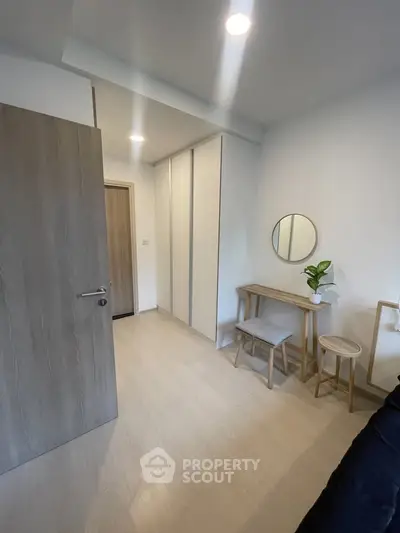 Modern minimalist bedroom with sleek furniture and ample storage space.