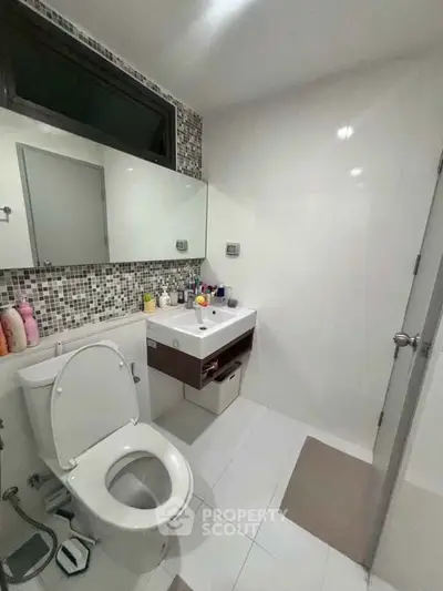 Modern bathroom with sleek fixtures and mosaic tile accents