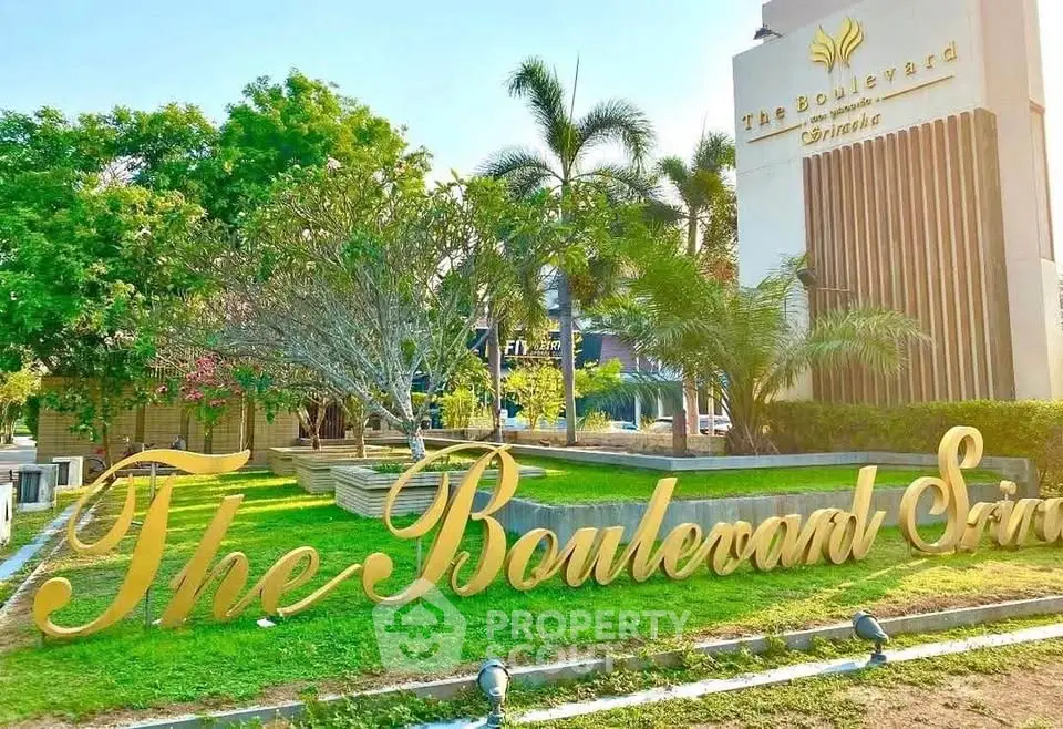 Luxurious entrance of The Boulevard with lush greenery and elegant signage.