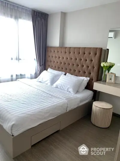 Elegant bedroom with plush headboard and natural light