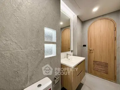 Modern bathroom with sleek design and wooden accents