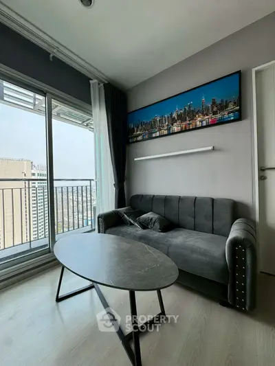 Modern living room with city view and stylish decor in high-rise apartment.