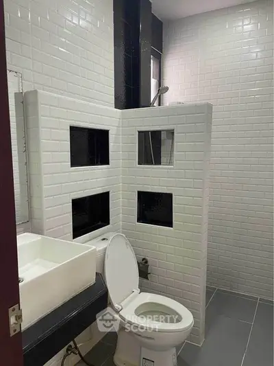 Modern bathroom with white subway tiles and sleek fixtures