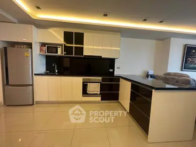 Modern kitchen with sleek cabinetry and built-in appliances in luxury apartment