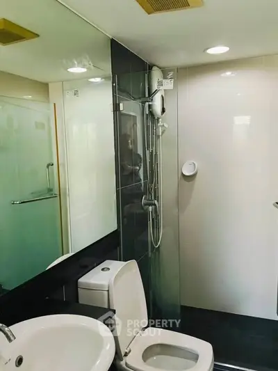 Modern bathroom with sleek fixtures and glass shower enclosure
