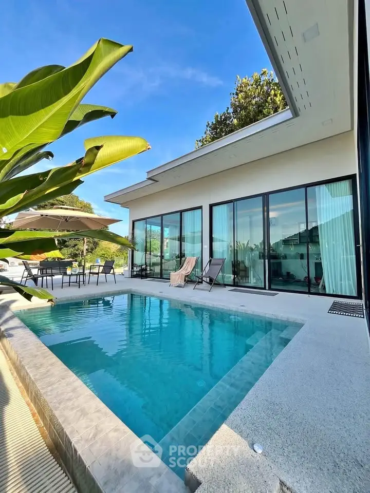Luxurious modern villa with private pool and spacious patio, perfect for relaxation and entertainment.