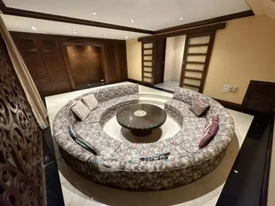 Luxurious sunken living room with circular seating and elegant decor