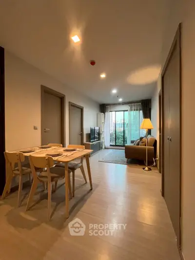 Modern open-plan living room with dining area and balcony view.