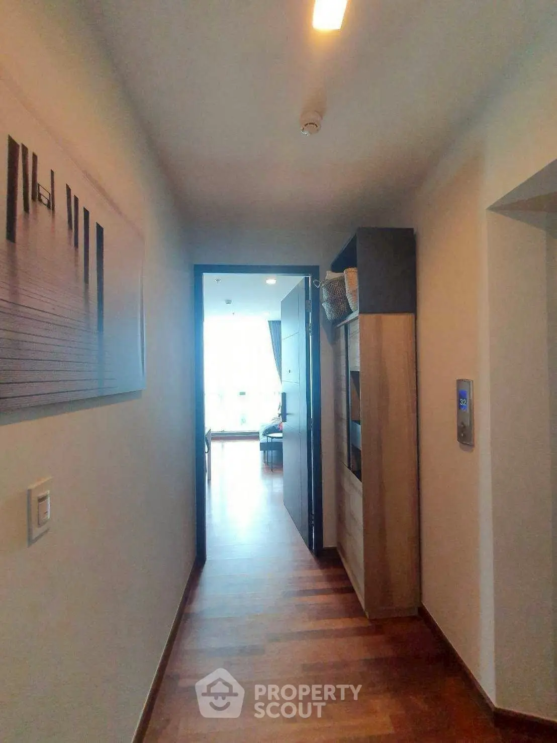 Modern apartment entrance with wooden flooring and stylish decor