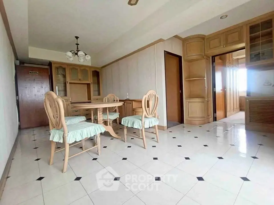 Spacious dining area with elegant wooden furniture and tiled flooring
