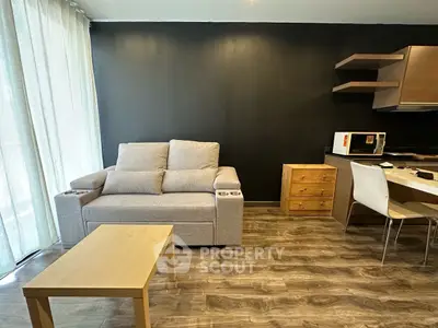 Modern living room with cozy sofa and stylish kitchen area