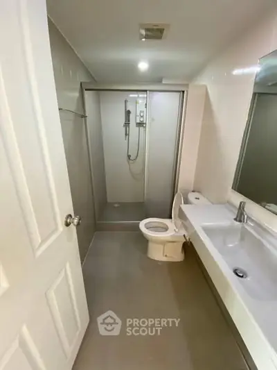 Modern bathroom with sleek shower and large sink area