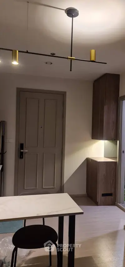Modern apartment interior with stylish lighting and sleek cabinetry