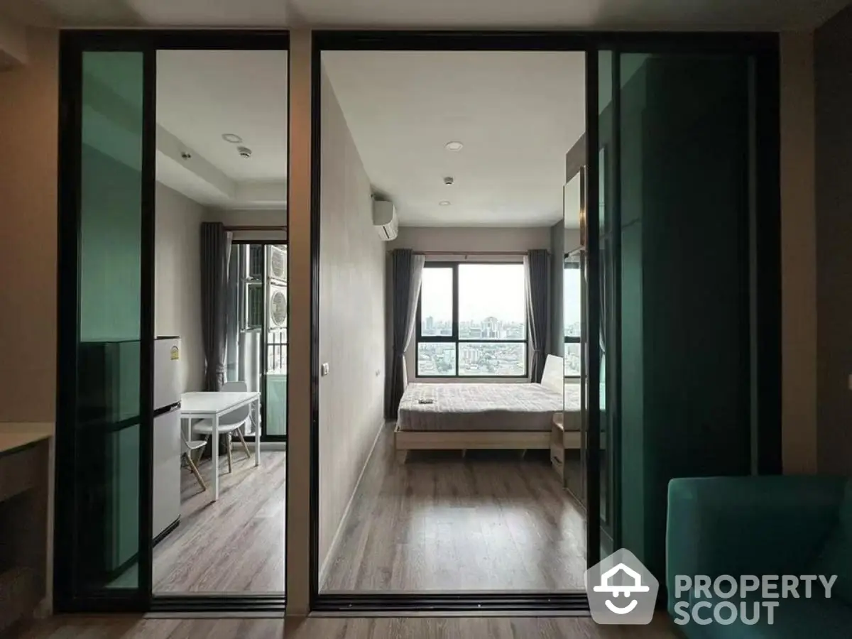 Modern apartment interior with sliding glass doors and city view