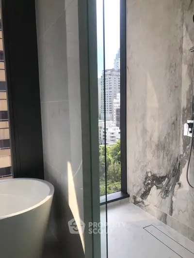 Luxurious bathroom with city view and elegant marble finishes