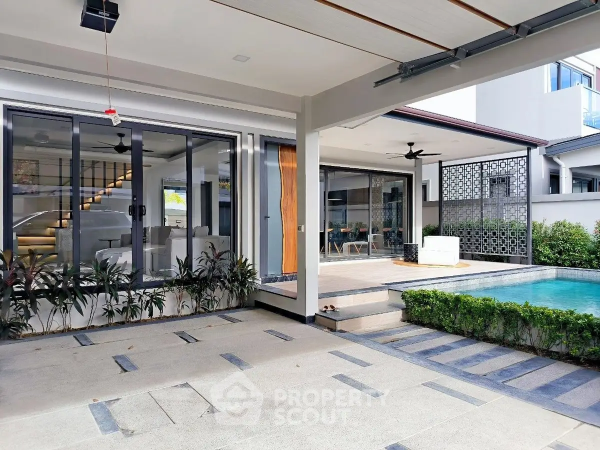 Modern luxury home with pool and stylish outdoor living area, perfect for relaxation and entertainment.