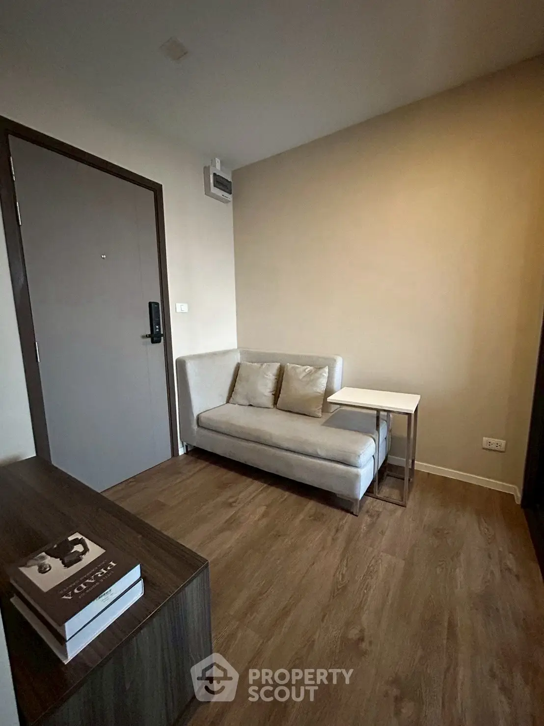 Cozy living room with modern sofa and wooden flooring in minimalist apartment.