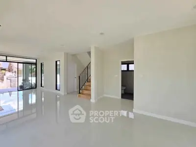 Spacious modern living room with glossy floors and large windows
