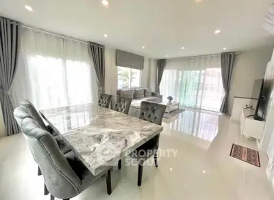 Spacious modern living room with elegant marble dining table and plush seating