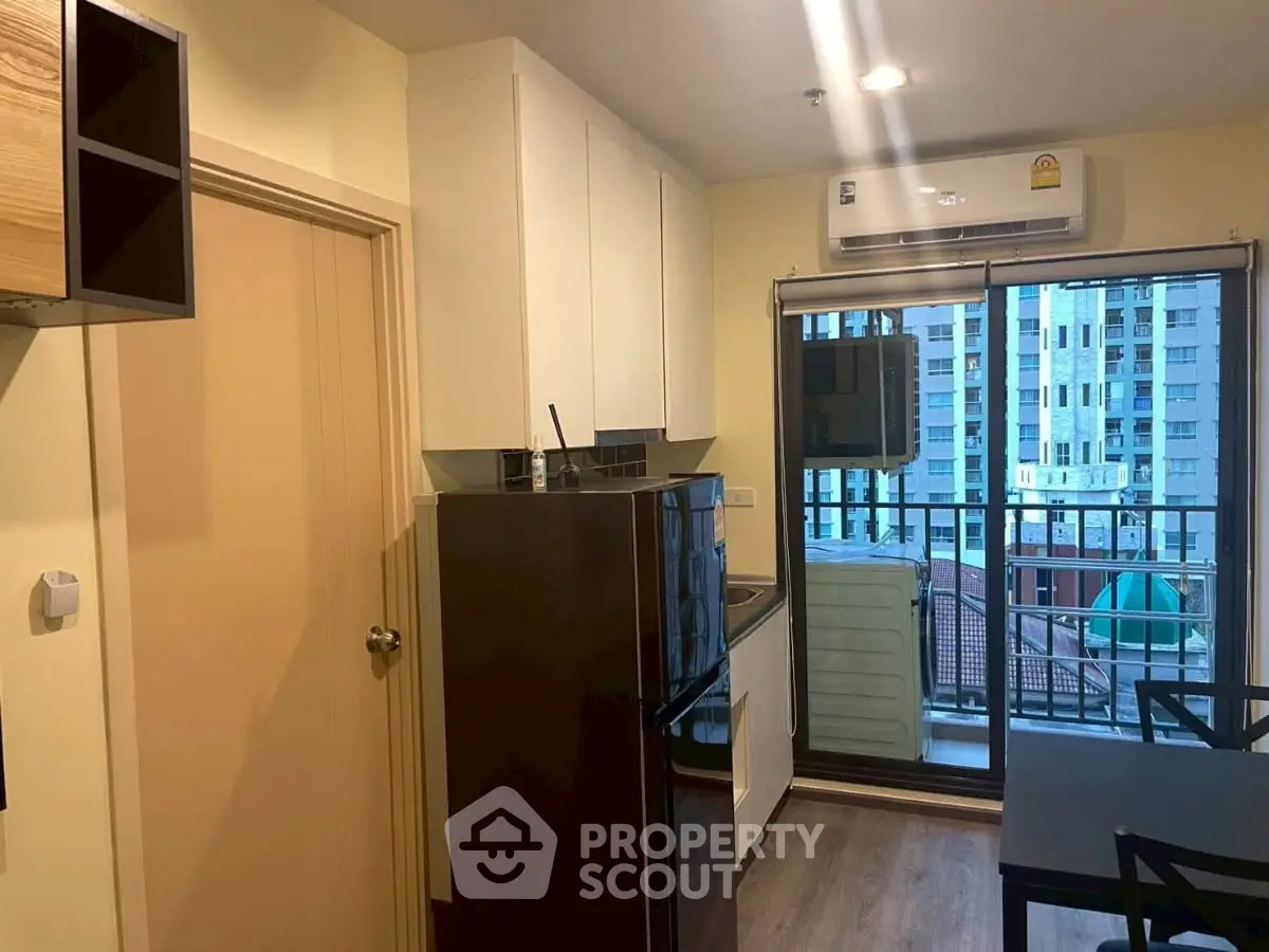 Modern kitchen with balcony view in urban apartment