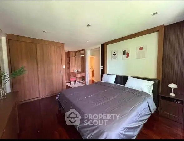 Spacious modern bedroom with wooden accents and stylish decor