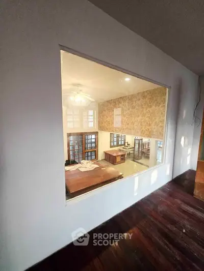 Spacious interior with high ceilings and elegant wooden flooring, perfect for modern living.