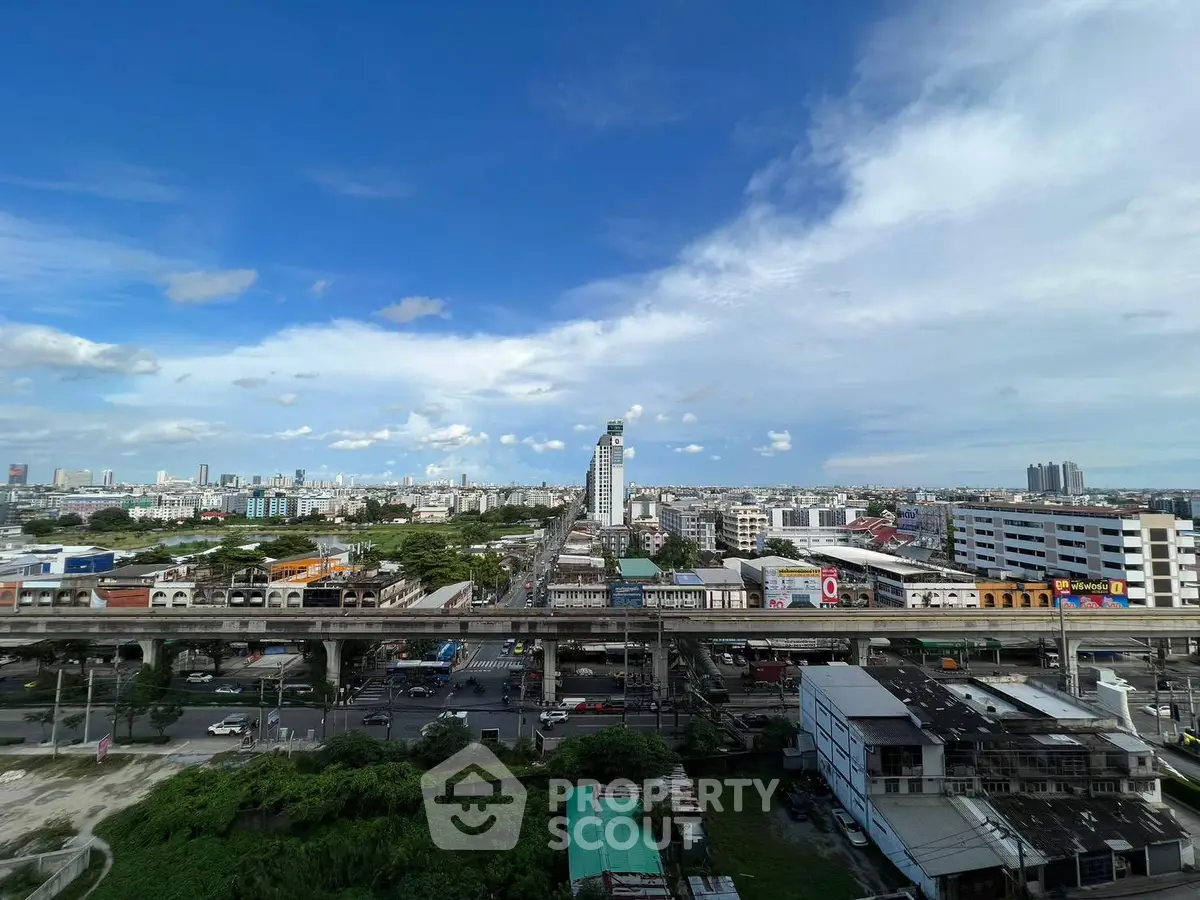 Stunning cityscape view from a high-rise building showcasing urban skyline and transportation infrastructure.