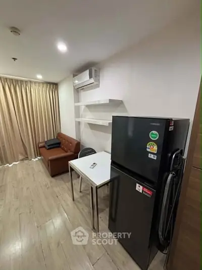 Modern living room with sleek furniture and appliances, featuring a cozy sofa and stylish shelving.