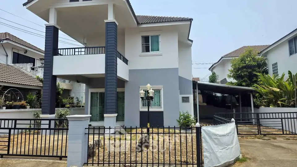 Charming two-story house with modern facade and spacious driveway in a serene neighborhood.