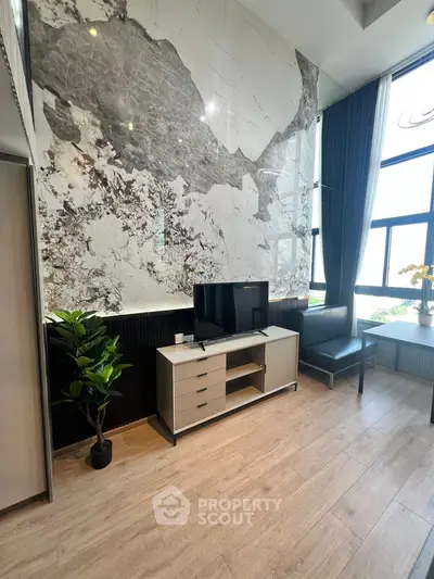 Modern living room with stylish marble accent wall and sleek furniture