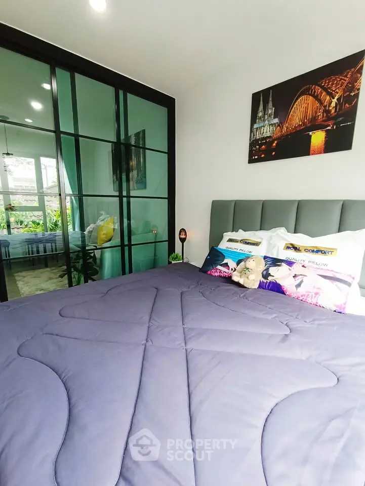 Cozy bedroom with modern decor and large mirrored closet doors, perfect for relaxation.