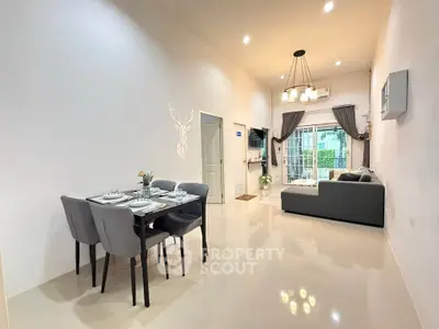 Modern open-plan living and dining area with elegant decor and ample natural light.