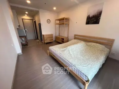 Spacious bedroom with wooden furniture and modern decor in a cozy apartment.