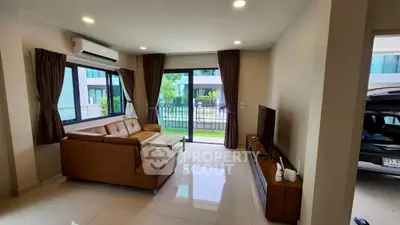 Spacious living room with modern furniture and garden view, perfect for relaxation.