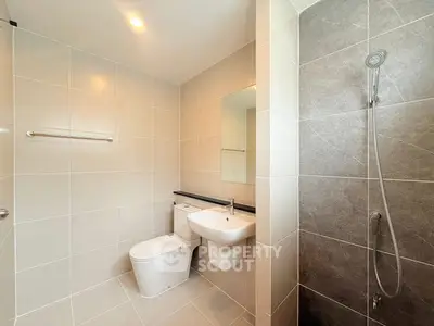 Modern bathroom with sleek fixtures and tiled walls