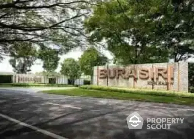 Beautiful entrance of Burasiri residential community with lush greenery and elegant signage.