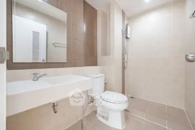 Modern bathroom with sleek fixtures and spacious shower area