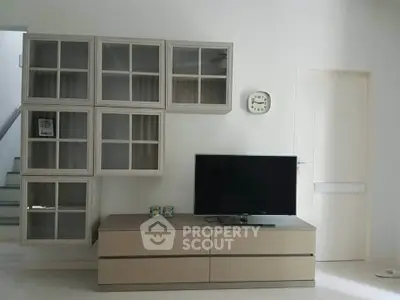Modern living room with stylish wall-mounted cabinets and sleek TV stand