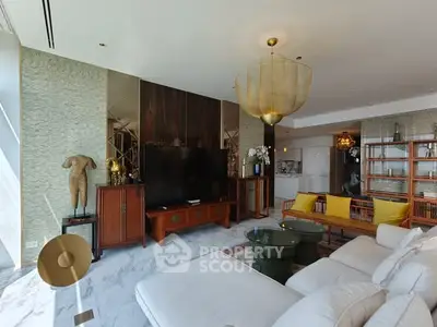 Luxurious living room with modern decor and large TV in upscale apartment