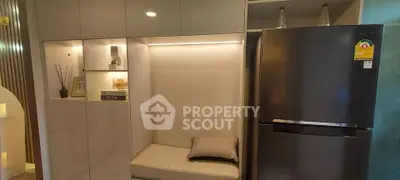 Modern kitchen with sleek cabinetry and stainless steel refrigerator