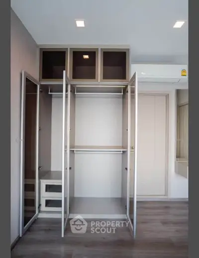 Spacious modern wardrobe with open doors in a stylish bedroom interior