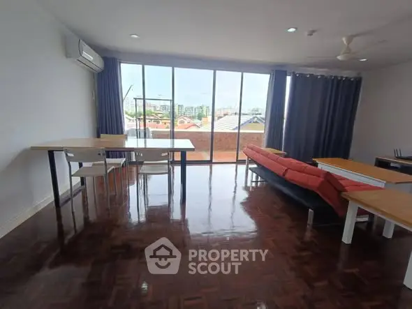 Spacious living room with large windows and modern furniture