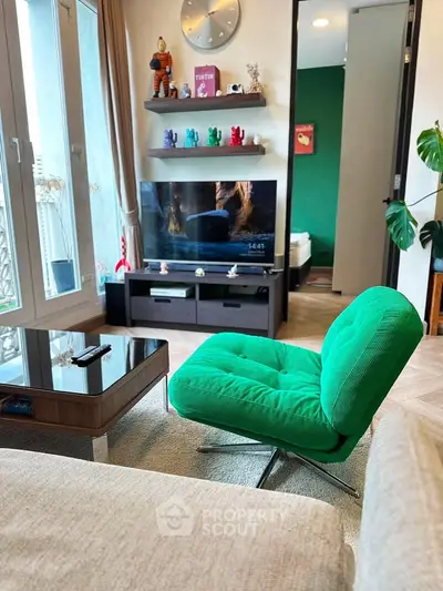 Stylish living room with modern green chair and sleek entertainment center