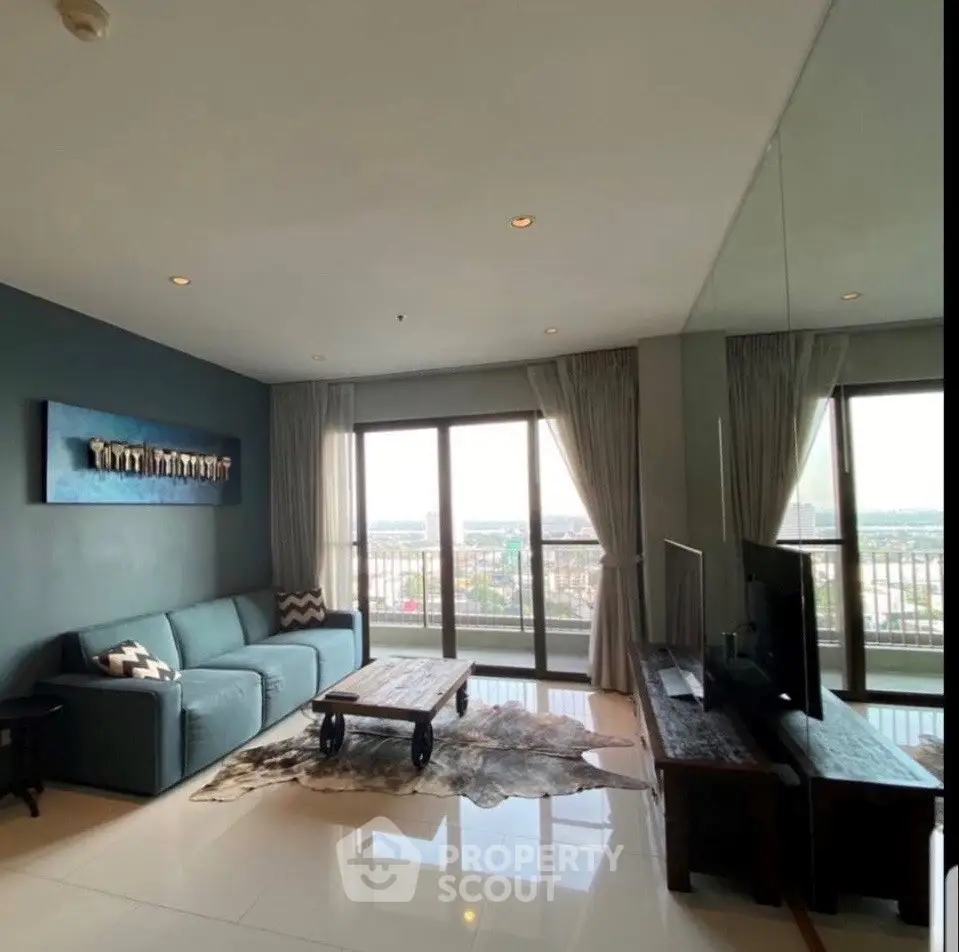 Spacious living room with panoramic city view and modern decor